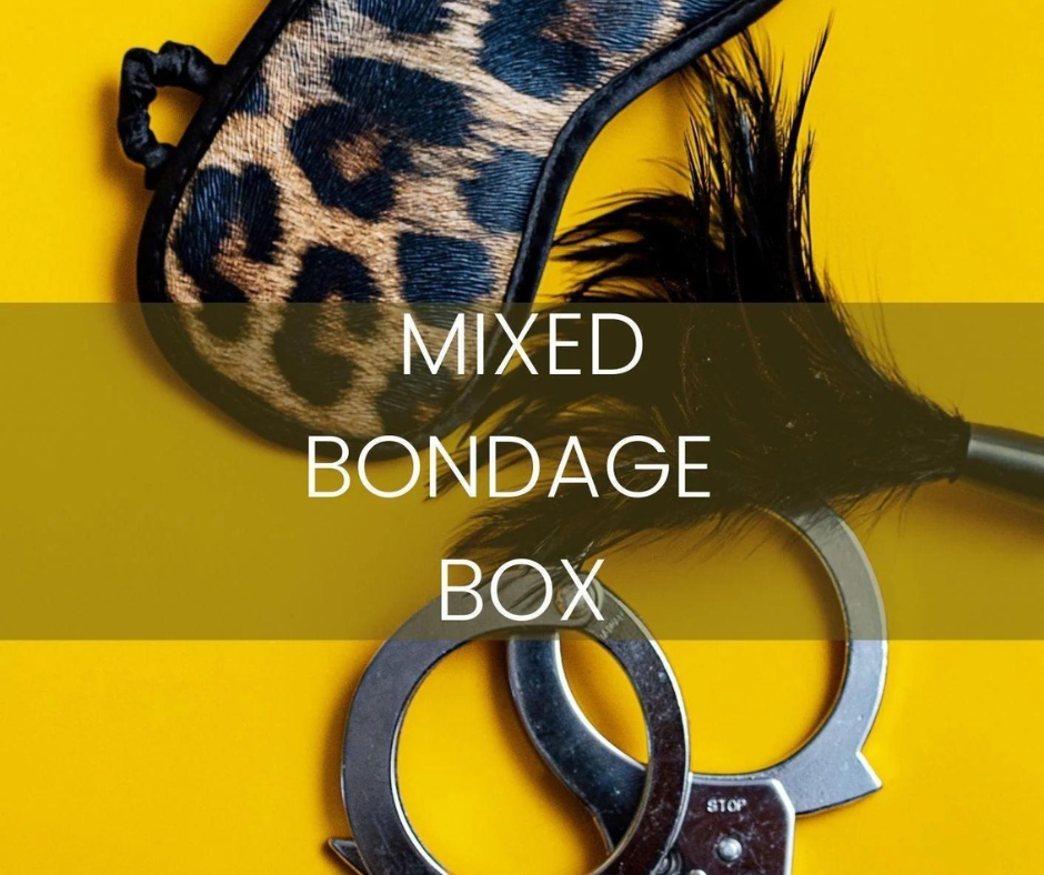 Yellow background with image of potential contents of Naked Curves Mixed Bondage Box, leopard print mask, silver handcuffs and a small black feather duster.
