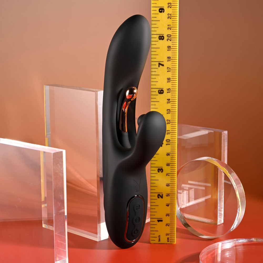 Black electronic device with a yellow measuring tape on a red surface